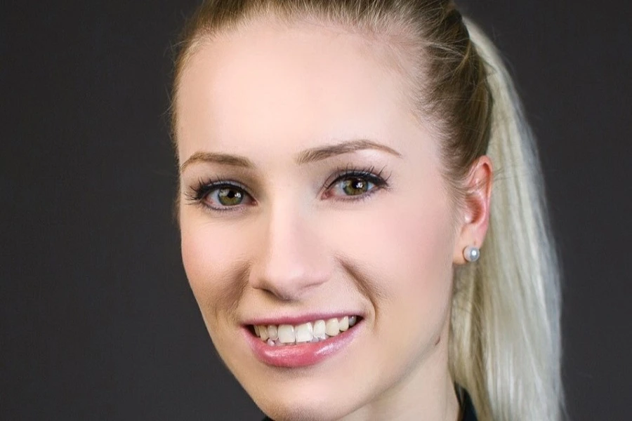 young woman with blonde hair in pony tail smiling